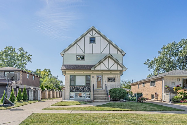 tudor-style house with a front lawn