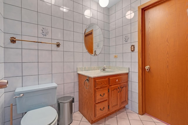 bathroom with vanity, tile walls, and tile patterned flooring