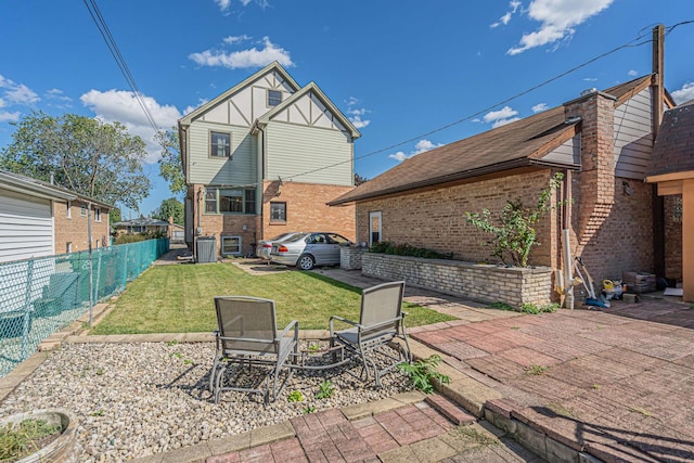 rear view of property featuring a patio area and a lawn