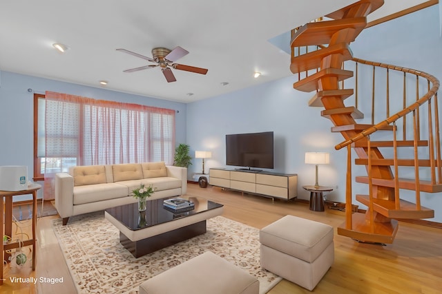 living room featuring light hardwood / wood-style floors and ceiling fan