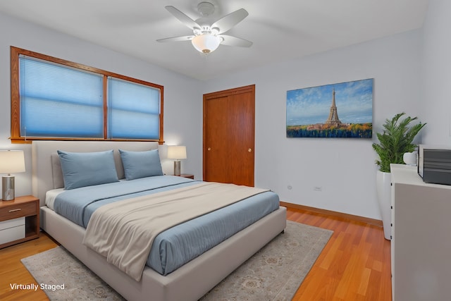 bedroom featuring light hardwood / wood-style floors and ceiling fan