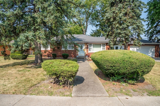 view of front of property with a garage and a front yard