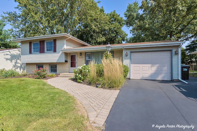 split level home with a garage and a front lawn