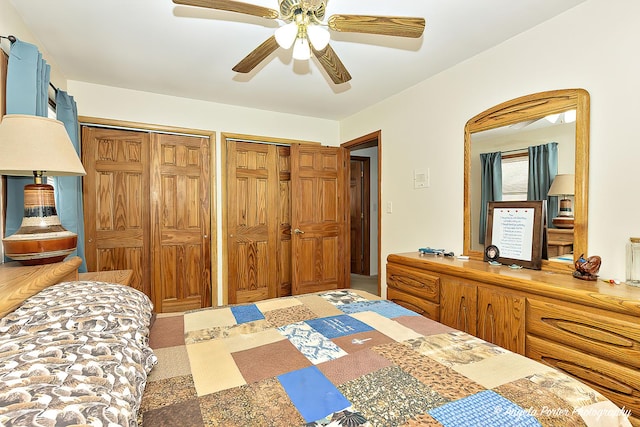 bedroom with a ceiling fan and multiple closets