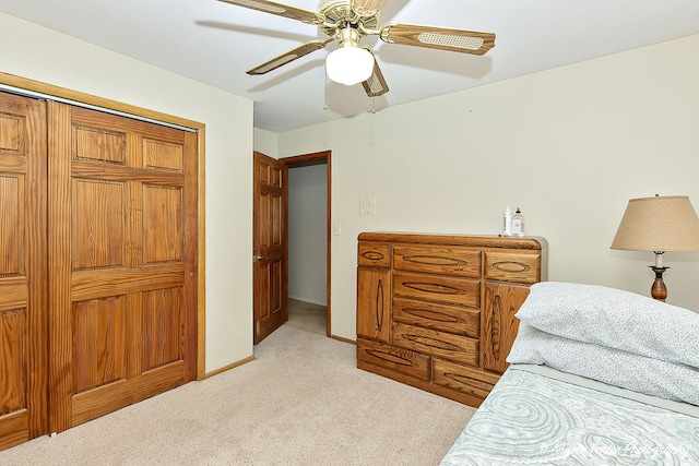 bedroom with light carpet, ceiling fan, and baseboards