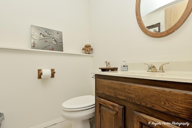 half bath with vanity and toilet