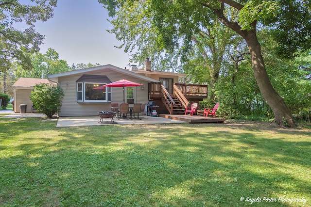 back of property featuring a lawn, a patio, a chimney, stairway, and a deck