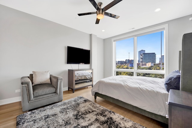 bedroom with light hardwood / wood-style flooring and ceiling fan