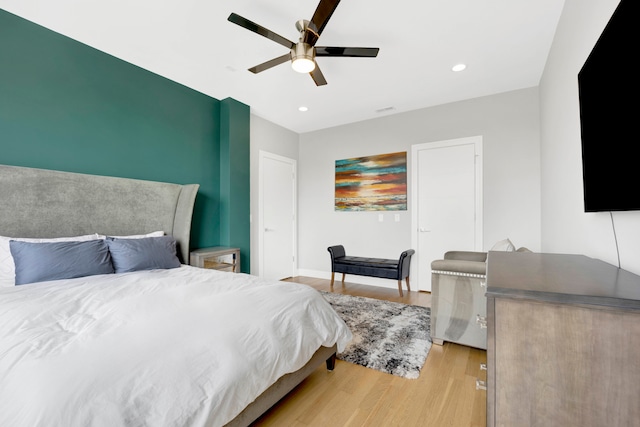 bedroom with light hardwood / wood-style flooring and ceiling fan