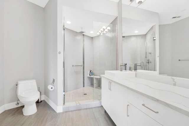 bathroom featuring walk in shower, vanity, and toilet