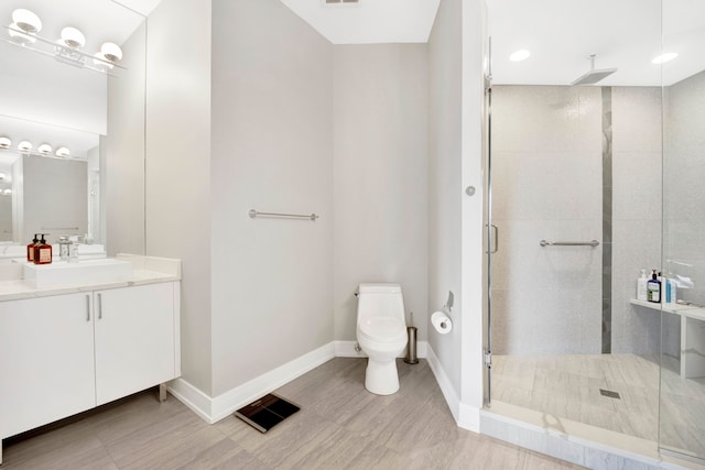 bathroom with vanity, toilet, an enclosed shower, and hardwood / wood-style flooring