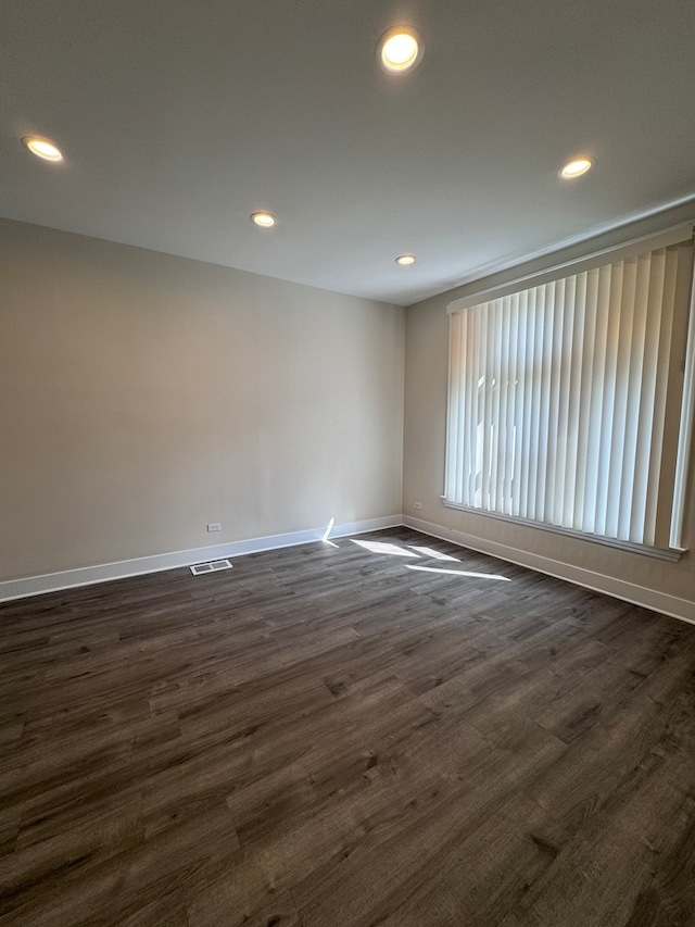 empty room featuring dark wood-type flooring