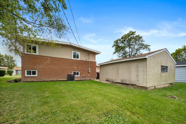 back of property with cooling unit and a yard