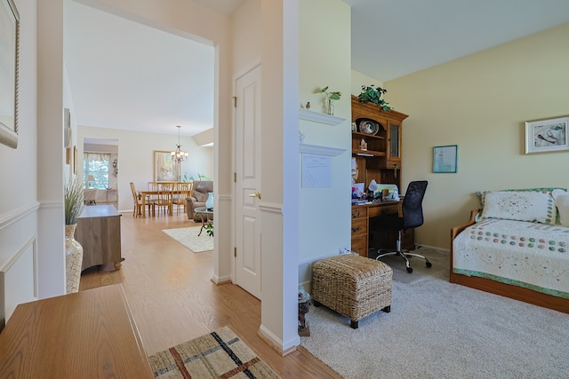 bedroom with a chandelier and light hardwood / wood-style floors