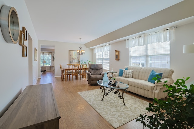 living room featuring light hardwood / wood-style flooring and a chandelier