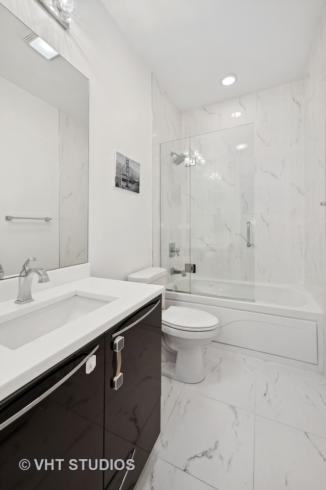 full bathroom with toilet, bath / shower combo with glass door, and vanity