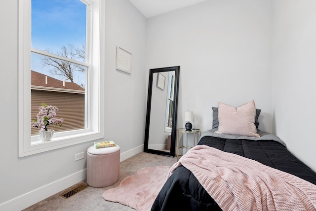 carpeted bedroom featuring baseboards and visible vents