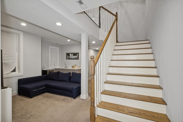 stairway featuring baseboards, carpet flooring, visible vents, and recessed lighting