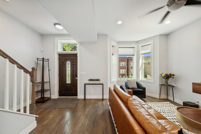 entryway featuring ceiling fan, dark wood-type flooring, stairway, and baseboards