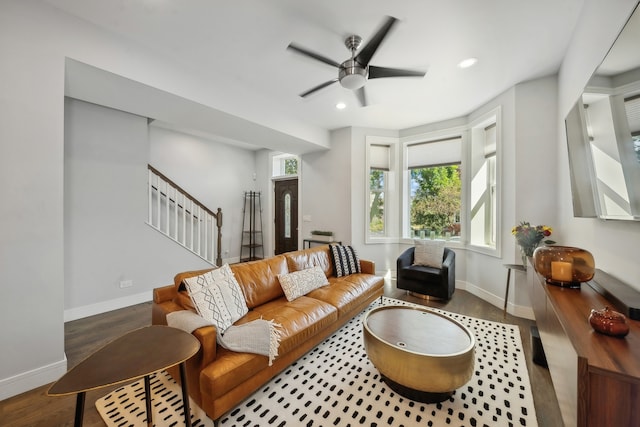 living area featuring baseboards, ceiling fan, stairway, wood finished floors, and recessed lighting