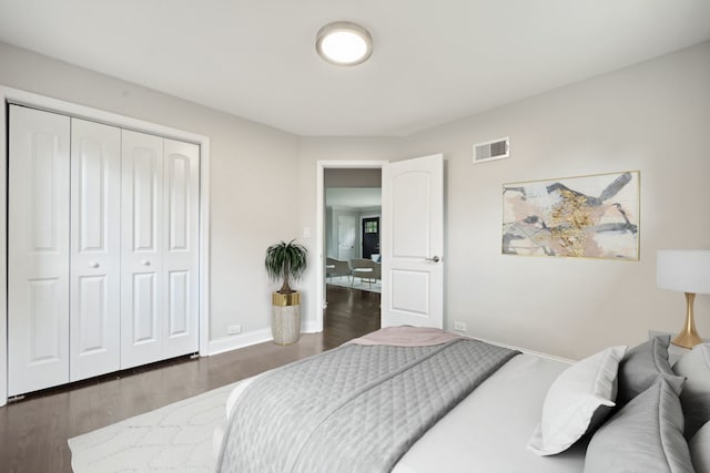 bedroom featuring a closet and dark hardwood / wood-style floors