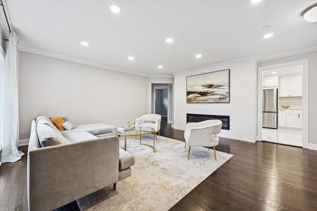 living room with dark hardwood / wood-style floors and crown molding