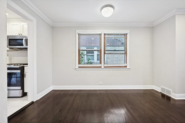 empty room with dark hardwood / wood-style flooring and ornamental molding