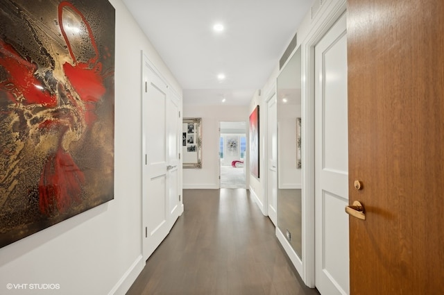 hallway featuring dark hardwood / wood-style flooring