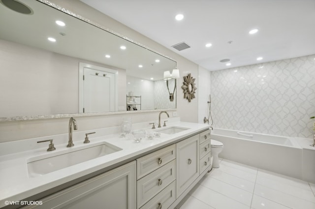 full bathroom with tile patterned flooring, vanity, toilet, and tiled shower / bath