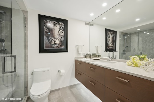 bathroom featuring vanity, toilet, tile patterned floors, and an enclosed shower