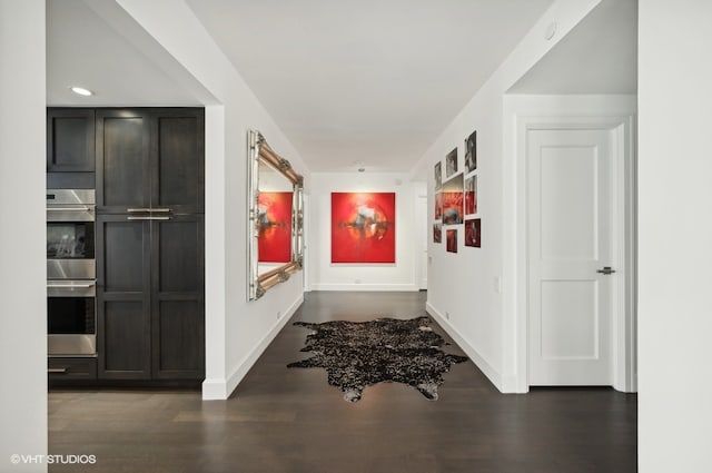 corridor with dark hardwood / wood-style floors