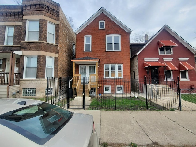 view of front of property with brick siding and a fenced front yard