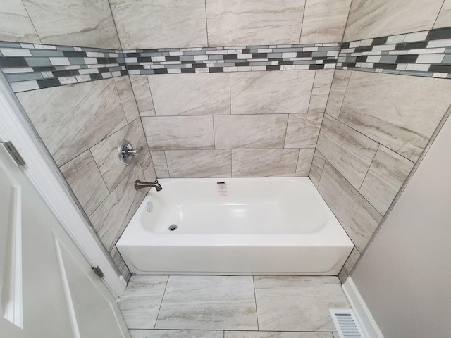 bathroom with visible vents and shower / tub combination