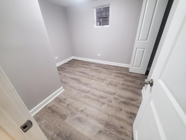 interior space with baseboards and wood finished floors