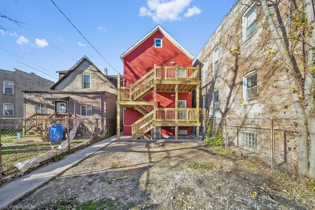 rear view of property featuring a balcony