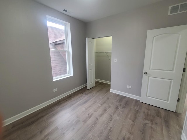 unfurnished bedroom with a closet and light hardwood / wood-style flooring