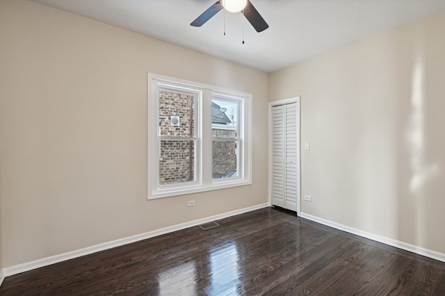 unfurnished room featuring ceiling fan and dark wood-type flooring