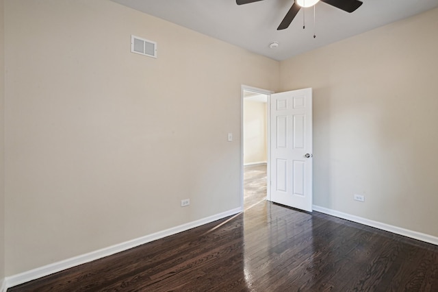 spare room featuring dark hardwood / wood-style floors and ceiling fan