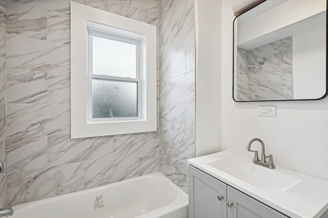 bathroom featuring tiled shower / bath and vanity