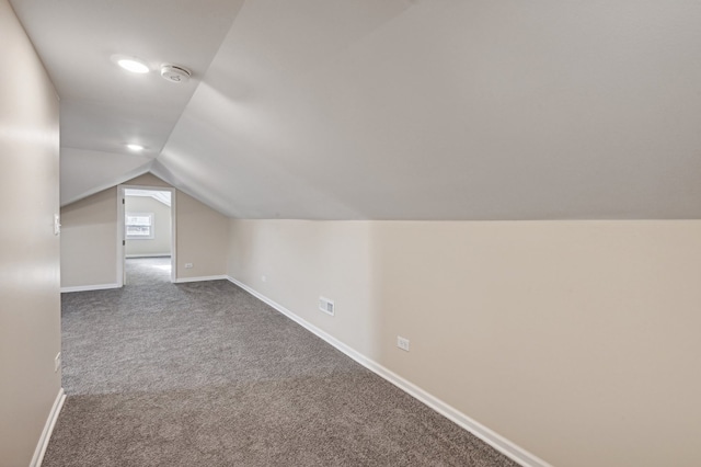 bonus room with carpet floors and vaulted ceiling