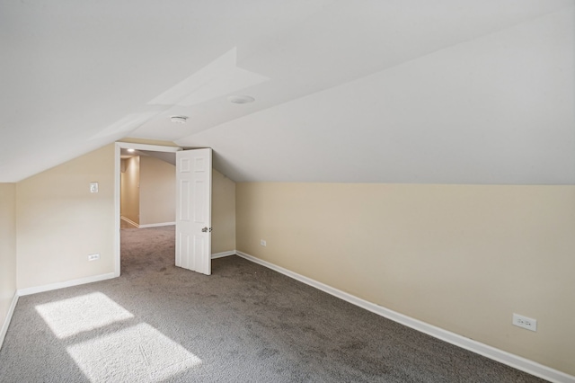 bonus room with vaulted ceiling and carpet