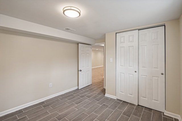 unfurnished bedroom with a closet and dark wood-type flooring