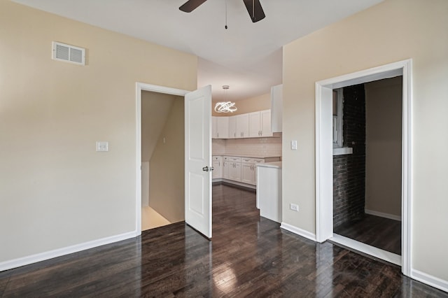 interior space with dark wood-type flooring and ceiling fan