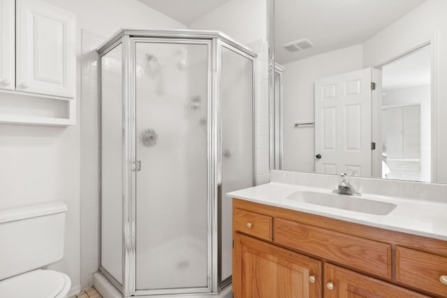 bathroom with vanity, an enclosed shower, and toilet