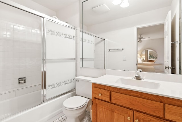 full bathroom with vanity, shower / bath combination with glass door, tile patterned flooring, ceiling fan, and toilet