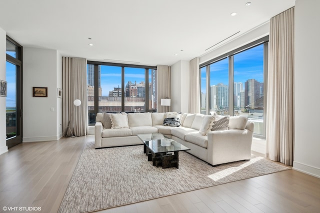 living room featuring light hardwood / wood-style floors and a wall of windows