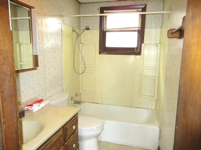 full bathroom featuring toilet, vanity, and  shower combination