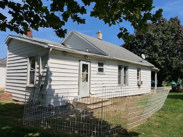 view of side of home featuring a lawn