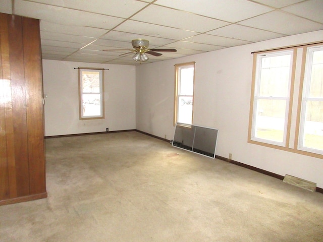 carpeted spare room with ceiling fan and a paneled ceiling