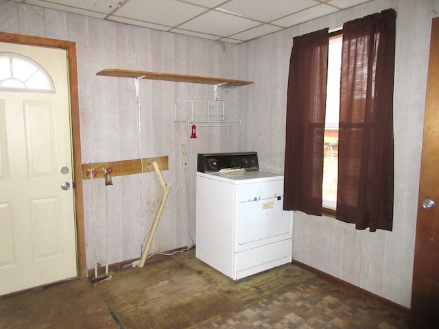 laundry area featuring wooden walls and washer / dryer